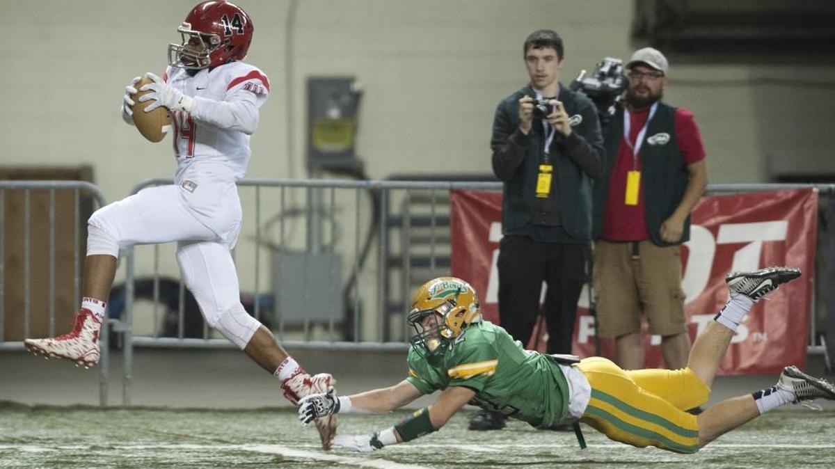 Archbishop Murphy wide receiver Anfernee Gurley leaps into the end zone just out of the grasp of Tumwater cornerback Jacob Crawford for a touchdown during the 2A football state semifinal game at the Tacoma Dome last year. Both Archbishop Murphy and Tumwater seemed destined for a collision course to play each other in the 2A state playoffs this season, but are both good enough to be playing in either 4A or 3A?