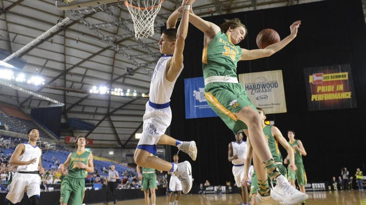 Richland’s Garrett Streufert (30) fouls Federal Way’s Rashon Slaughter (31) in the third quarter Thursday at the Tacoma Dome. Both the WIAA and the Washington Interscholastic Basketball Coaches Association agree the new RPI system used for seeding is in line to be tweaked before next season.