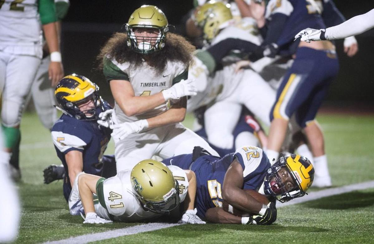 Bellevue running back Isaiah Ifanse pops into the end zone for a one-yard touchdown run during Saturday night's 3A state football quarterfinal game against Timberline at Bellevue High School on Nov. 18, 2017.