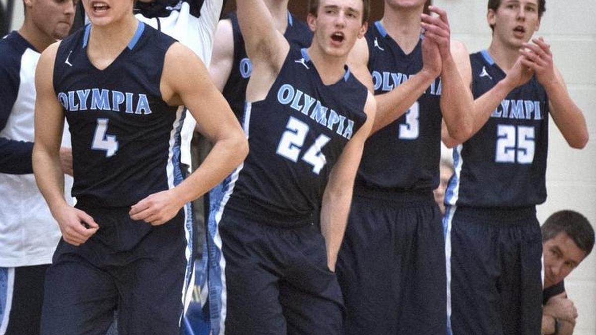 Olympia High School players Hunter Sipe (4), Liam Murphy (24), David Woodward (3), Dayne Shafer (25) and other teammates celebrate a 3-pointer as the Bears jump out to a 30-point lead over the Tigers at Stadium High School in a 4A Narrows League game.