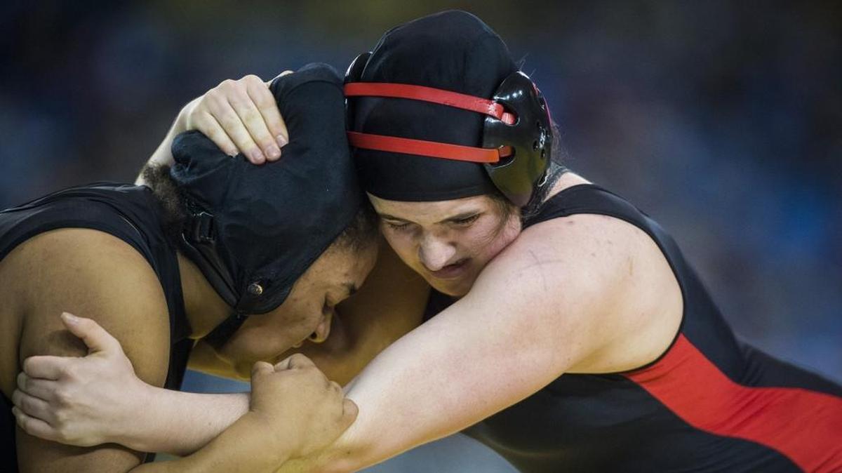 Shelton’s Quinn Lacy, right, and Mount Baker’s Jada Tarvin, left, grapple in a 170-pound match at Mat Classic XXX at the Tacoma Dome in Tacoma, Wash., on Friday, Feb. 16, 2018.
