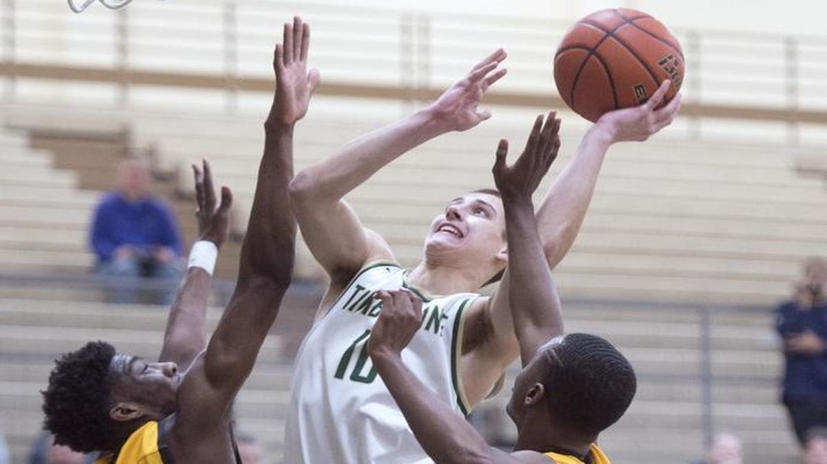Timberline's Erik Stevenson flies to the basket against Lincoln defenders Willie Thomasill (5) and Emmett Linton during Wednesday night's 3A West Central/Southwest bi-district boys basketball semifinal game at Olympia High School on Feb. 15, 2017.