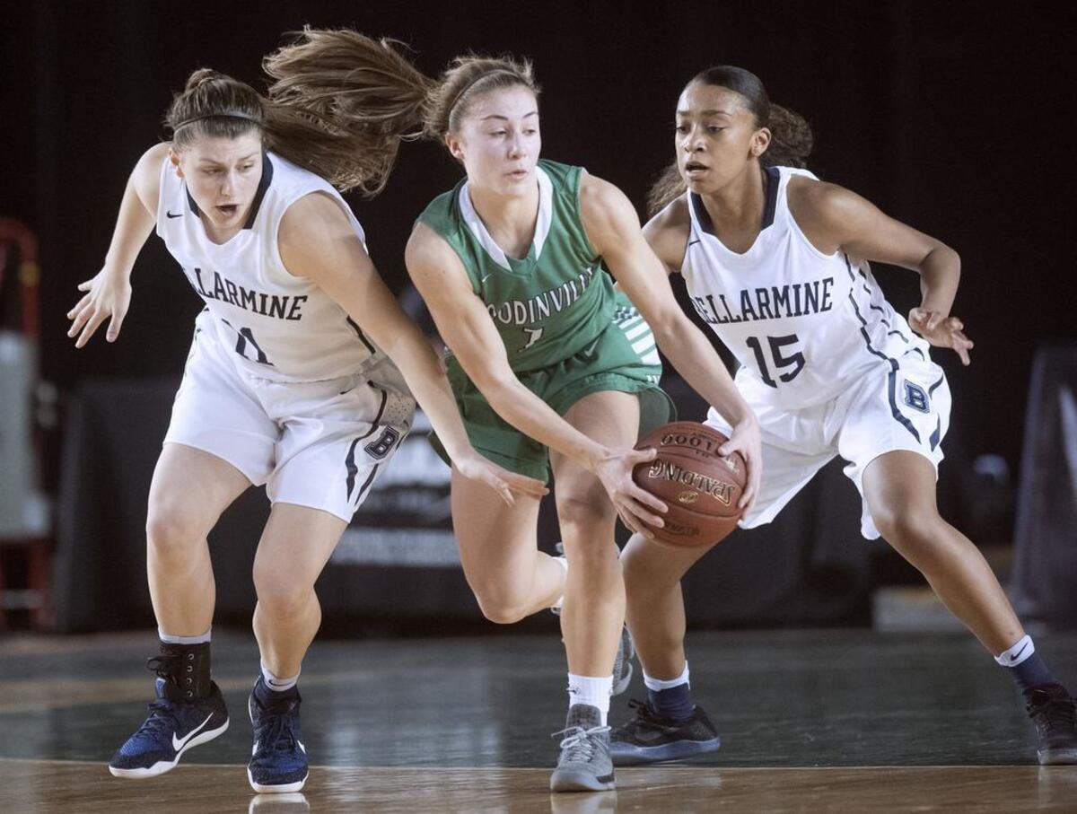 Woodinville’s Regan Schenck is pressured by Bellarmine Prep defenders Jenny Hagle (left) and Reyelle Frazier during Wednesday afternoon’s 4A girls basketball state tournament game in the TacomaDome on March 1, 2017.