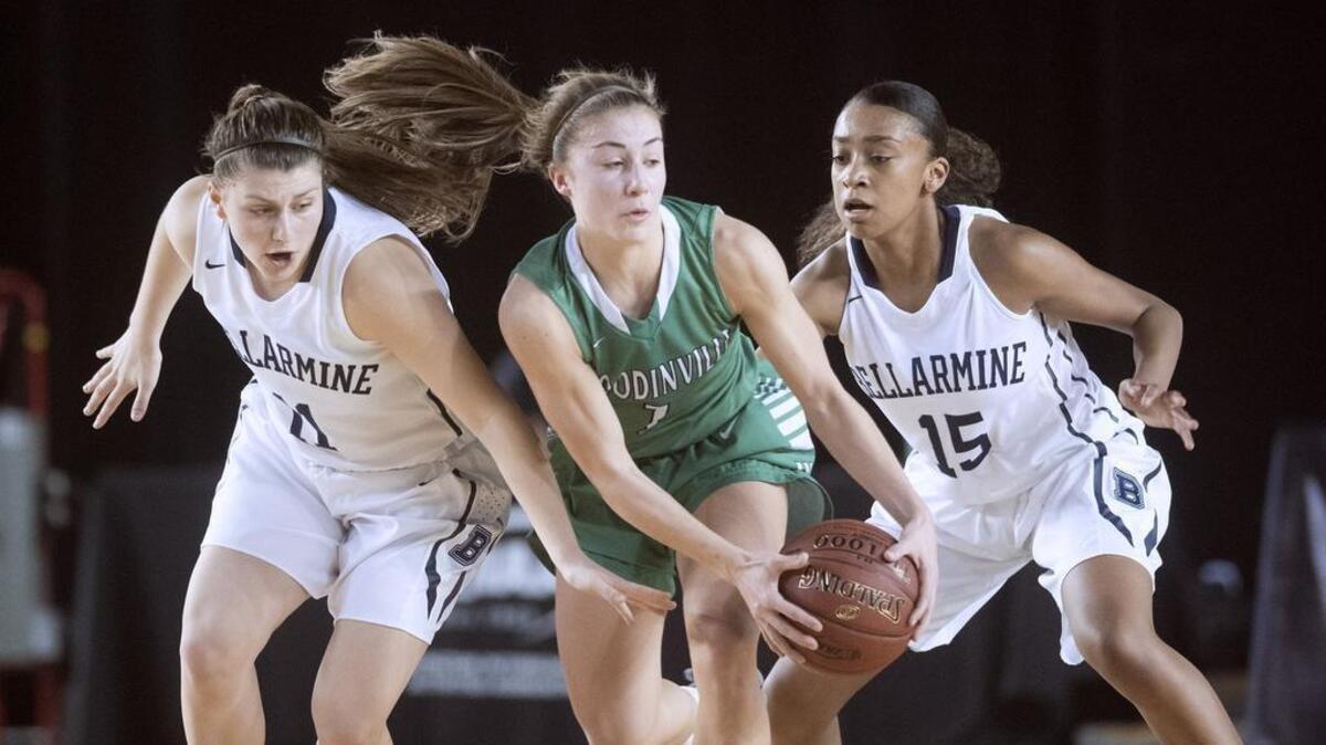 Woodinville’s Regan Schenck is pressured by Bellarmine Prep defenders Jenny Hagle (left) and Reyelle Frazier during Wednesday afternoon’s 4A girls basketball state tournament game in the TacomaDome on March 1, 2017.