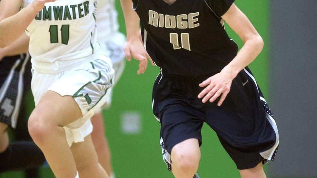 River Ridge’s Caitlin Yenne pushes the ball up the court in front of Tumwater’s Sophia Koelsch during the Hawks’ 40-29 victory on Friday night.