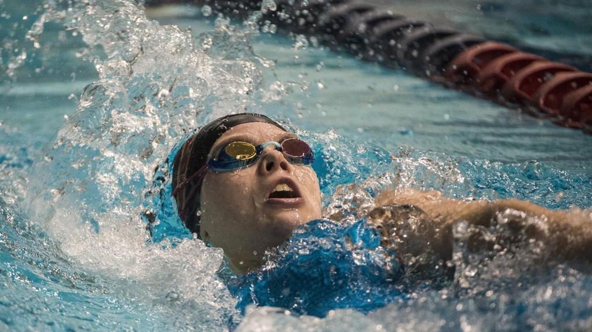 Capital's Camden Martin competes in the 100-yard backstroke at the 3A girls state swim and dive championships at the King County Aquatics Center in Federal Way, Wash., on Saturday, Nov. 11, 2017.