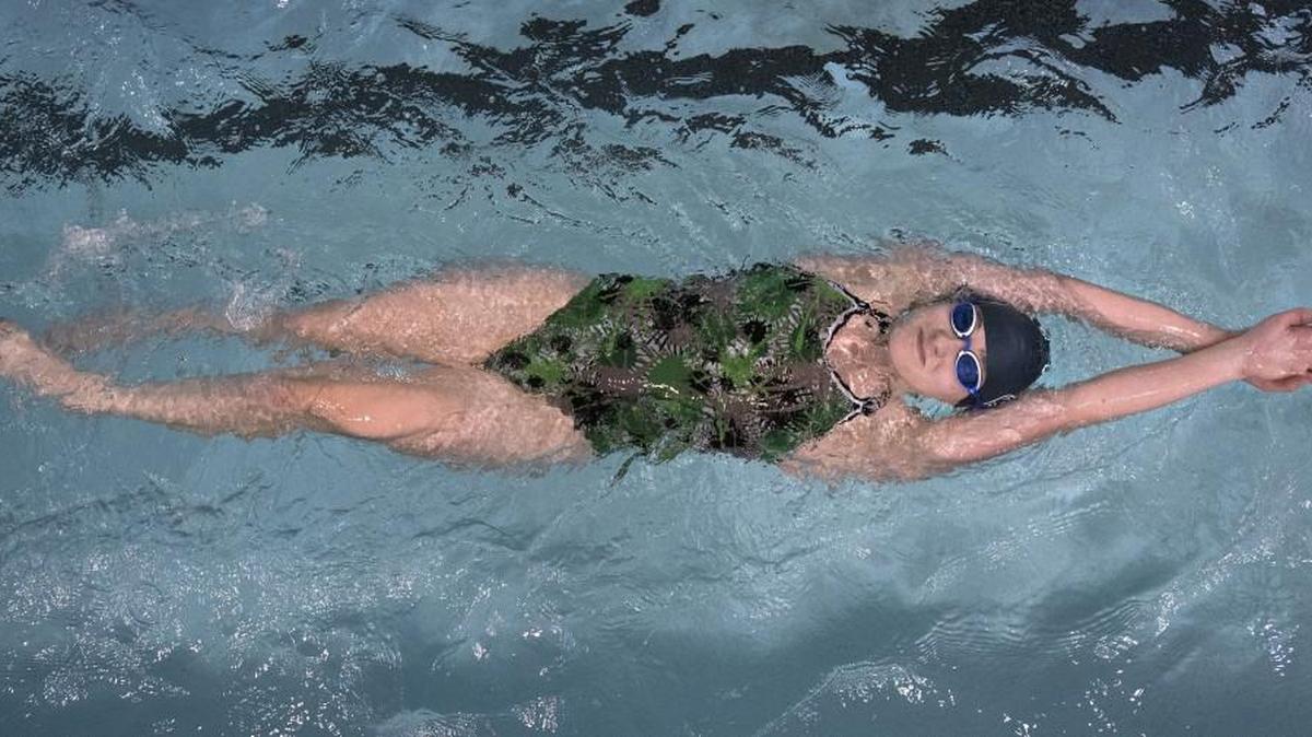 
Olympia High School junior captain Maya Hansen-Tilkens, who has set her sights on qualifying for state in the freestyle sprint events, cruises through the pool at The Evergreen State College in Olympia during swim practice.
