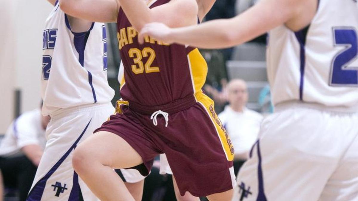 Capital's Palen Fenton drives to the basket between North Thurston defenders Lauren Bailey (left) and Quinlan Christian during Wednesday night's 3A Narrows League girls basketball game at the North Thurston High School gym in Olympian on Jan. 20, 2016.