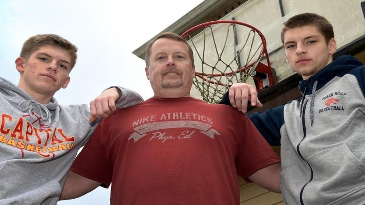 Black Hills assistant basketball coach Troy Mickelson, center, stands with his two sons Matthew, left, who plays for Capital and T.J., right, who plays for the Wolves.