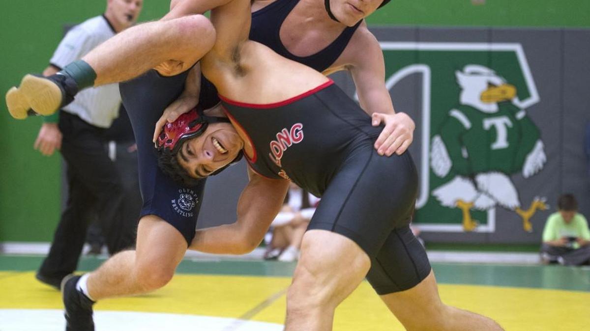 Olympia's Gabe Peterson (top) counters a takedown move by David Jimenez of R.A. Long during their 152-pound semifinal match at the Pat Alexander Invitational Wrestling Tournament at Tumwater High School. Peterson won the match, 5-2 in overtime.