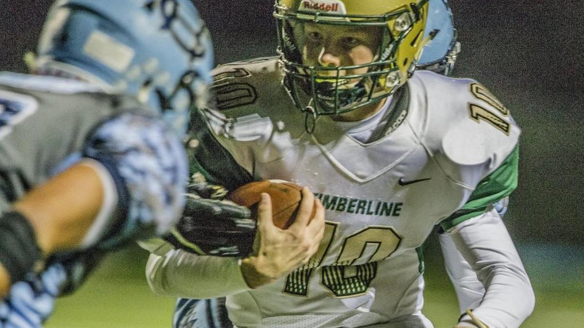 Blazers quarterback Hunter Campau (10) keeps the ball for a short gain during the Timberline vs. Gig Harbor football game at Anderson Field in Purdy, Wash., Friday, Oct. 13, 2017.