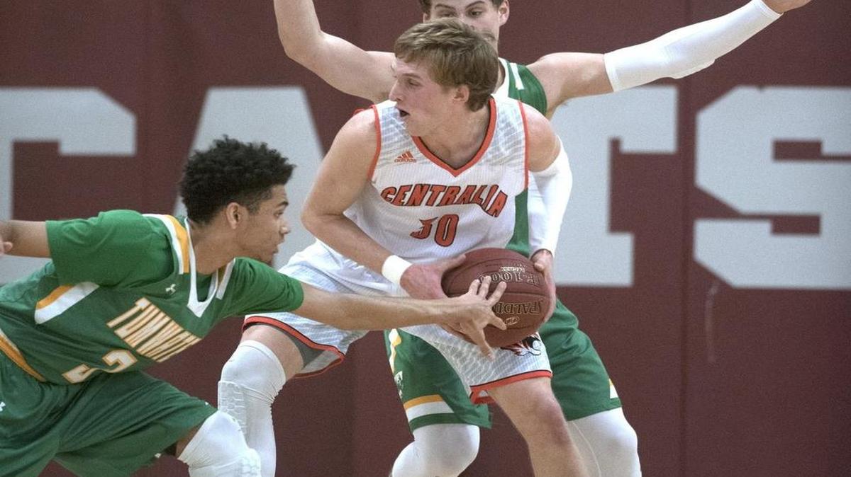 Centralia’s Hodges Bailey gets harassed by Tumwater defenders CJ Geathers (left) and Brian Marty harass during Thursday night's boys basketball playoff game at W.F. West High School in Chehalis on Feb. 16, 2017.