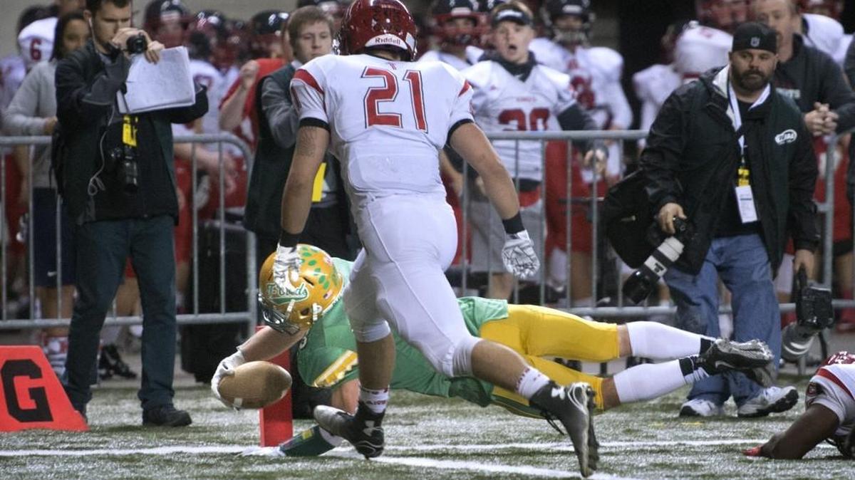 Tumwater’s Noah Andrews dives into the end zone ahead of Archbishop Murphy defender Austin Earl for the go-ahead touchdown late in the 2A semifinal at the Tacoma Dome in November 2015. Tumwater won, 24-21, ending the Wildcats’ up-until-then perfect season.