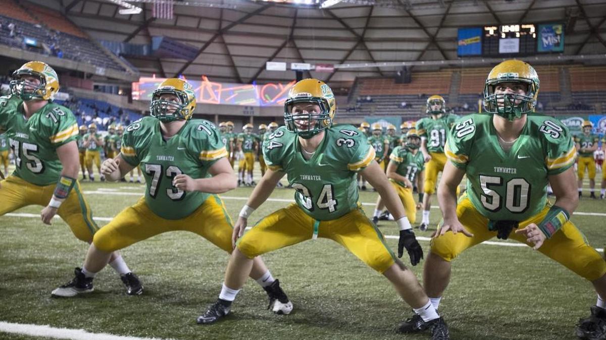 Tumwater players, from left, Bailey Snow, Dakoda Keller, Caleb Jelcick and Cy Hicks run through warmups before their 2A football state championship game against the Prosser Mustangs in the Tacoma Dome on Saturday, Dec. 5, 2015.