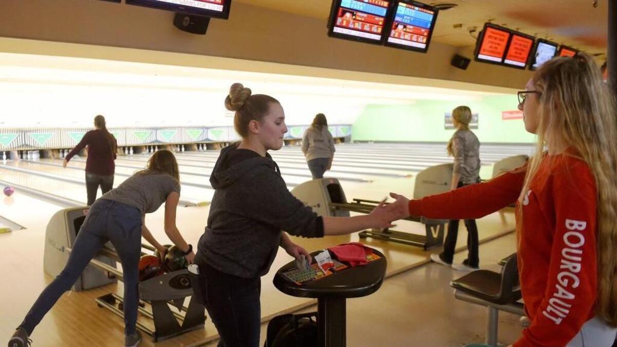 Highclimber's Kaylee Schilter (right) high fives Rebecca Robinson after she picked up a spare during the team's Monday practice at the Westside Lanes in Olympia.
