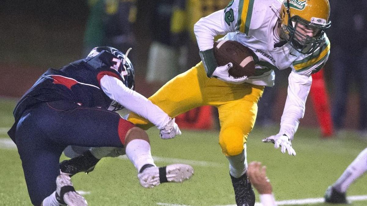 Tumwater running back Jakob Holbrook tries to break free from Black Hills defensive back Wyatt Rollman during Friday night’s Pioneer Bowl crosstown rivalry game at Tumwater District Stadium on Oct. 20, 2017.