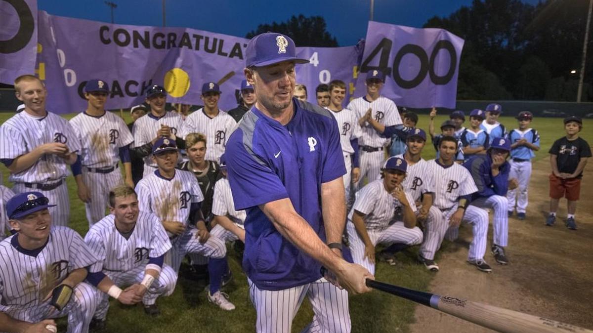 Puyallup head coach Marc Wiese tries out his ceremonial bat presented by parents to commemorate his 400th win following Tuesday’s 4A West Central District baseball tournament victory over Thomas Jefferson, 10-0, at Art Wright Field in Kent.
