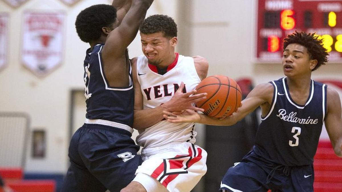 Yelm’s Christian Davis, center, runs into the defense of Bellarmine Prep’s Ahmad Lewis and Charles Elzie (3). Davis led all scorers with 22 points.