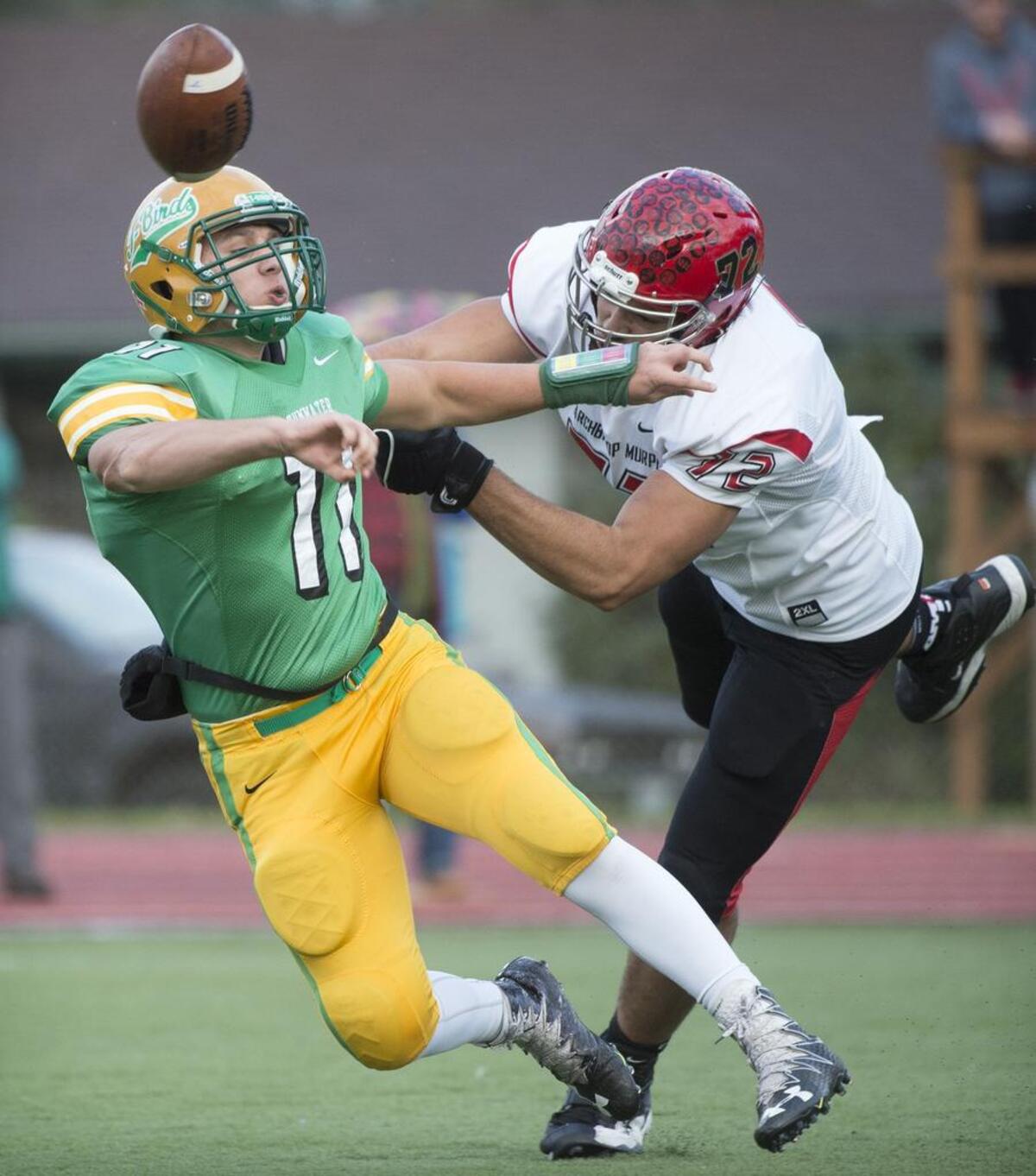 Tumwater quarterback is tossed down by Archbishop Murphy defender Abraham Lucas during Saturday’s state quarterfinal at Tumwater District Stadium on Saturday, Nov. 19, 2016.