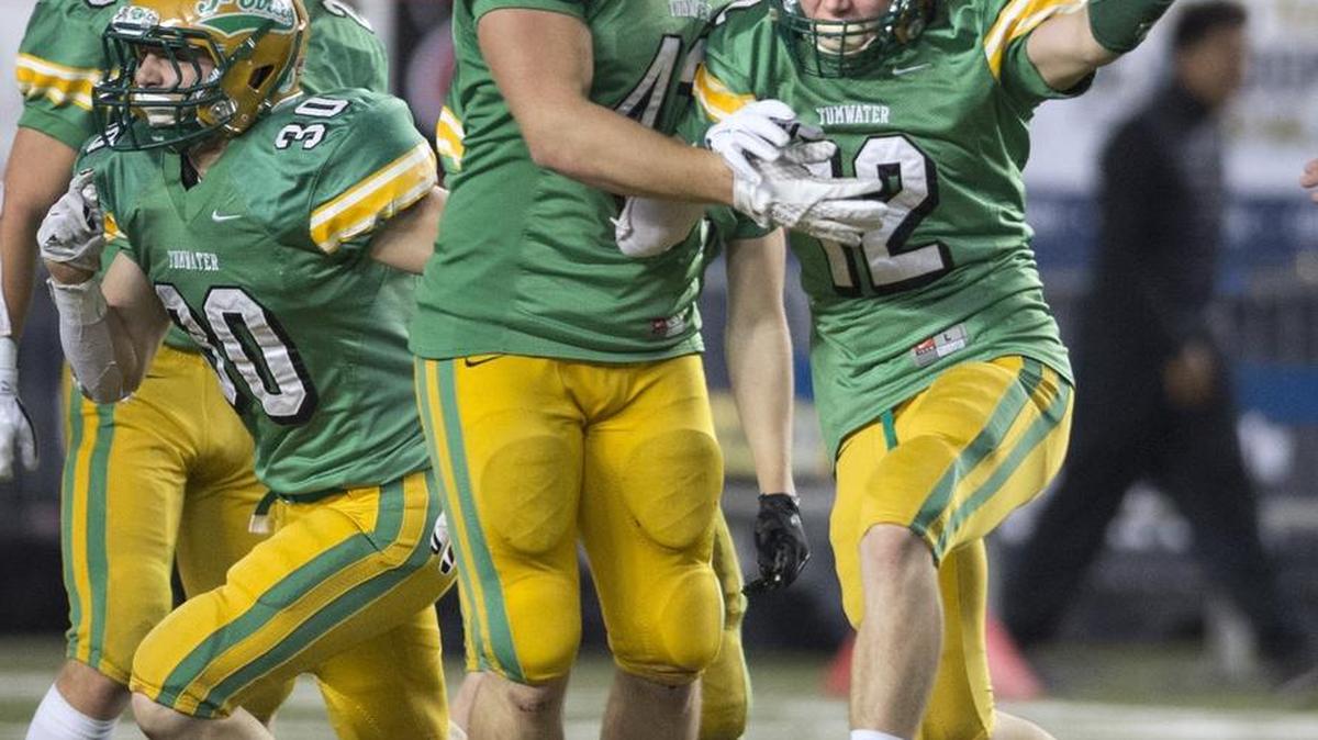 Tumwater’s Noah Andrews (from left), Zach Jones, Hunter Haggerty and Jacob Crawford celebrate a Crawford pick.