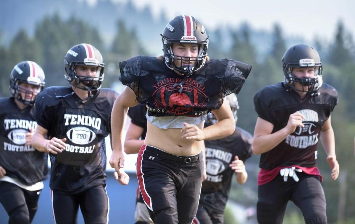 Tenino defensive lineman Tyrick Weyrauch leads his teammates through warm-ups during a preseason football practice at Tenino Middle School on Tuesday, Aug. 22, 2017.
