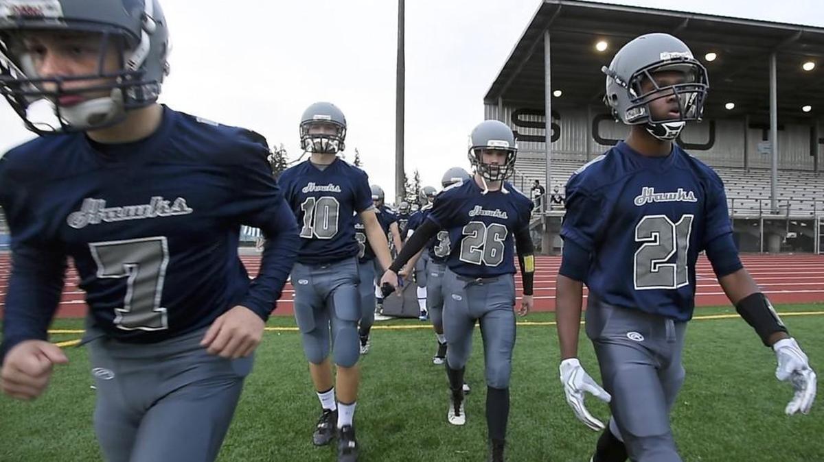 
River Ridge's Christopher Tomczewski (7), Ian Meyer (10), Robert Armstrong (26) and Derrick Smith enter the field before Friday night's football game against Franklin Pierce at South Sound Stadium in Lacey on Sept. 18, 2015.
