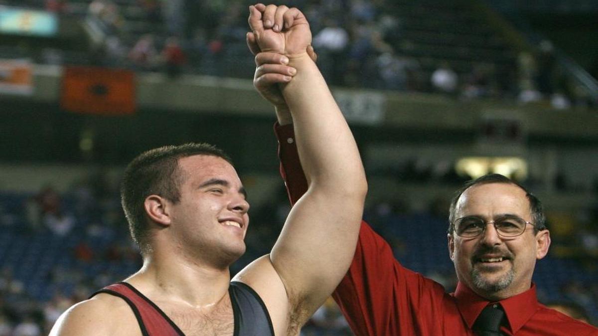 Yelm wrestling coach Gaylord Strand (right) celebrates with Marcus Turnquist following the senior's 9-5 victory over Erik Magnussen of Eastmont in the 215-pound state championship at Mat Classic XX in the Tacoma Dome, on Saturday, Feb. 16, 2008.