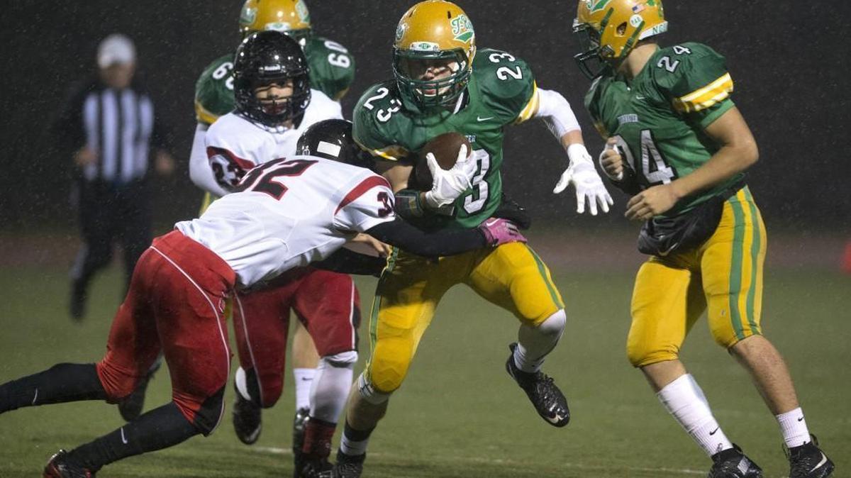 Tumwater running back Noah Andrews (23) tries to fight off Franklin Pierce defensive back Cameron Myers during Friday night's 2A football state playoff game at Tumwater District Stadium on Nov. 13, 2015.