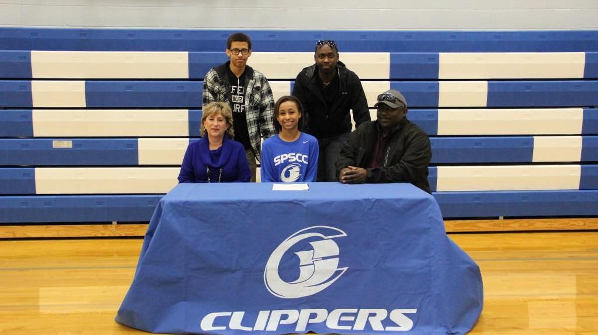SPSCC's first volleyball recruit, Stephanie Washington, signs her letter of intent surrounded by family.