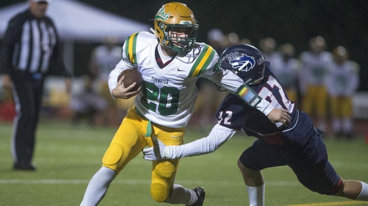 Tumwater running back Connor Clark tries to fight off Black Hills defensive back Wyatt Rollman during Friday night's Pioneer Bowl crosstown rivalry game at Tumwater District Stadium on Oct. 20, 2017.
