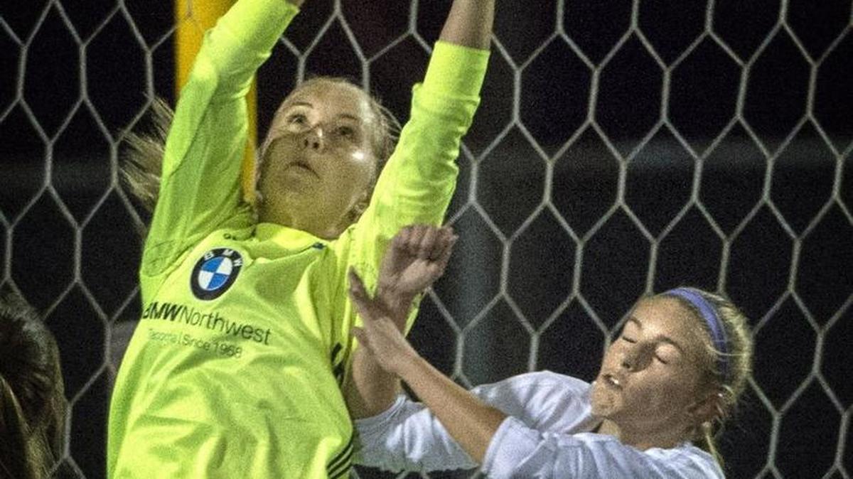 Olympia goalie Carly Becker secures a Puyallup pass to Viking's Katie Cunningham before she could head the ball for a goal at Sparks Stadium in Puyallup on Tuesday, Sept. 272016. Story, 8B