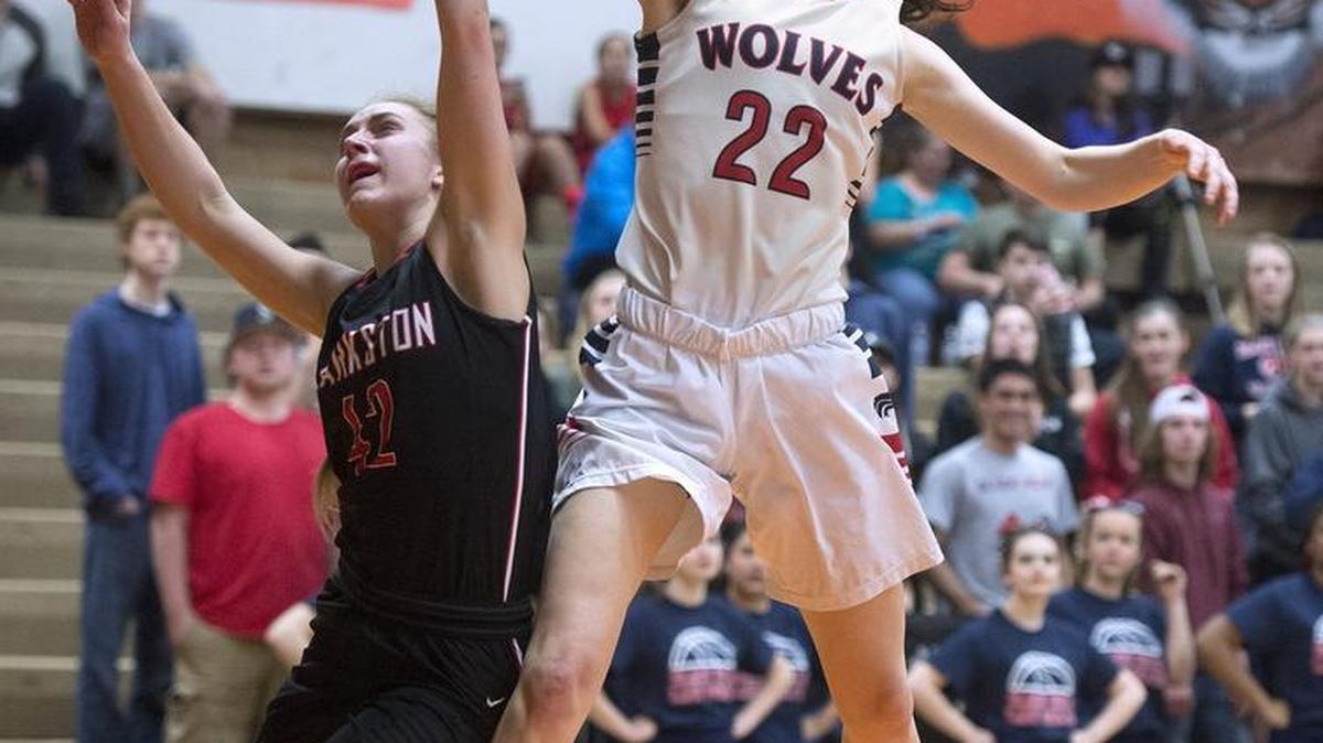 Black Hills’ Emma Duff (22) flies down the lane over Clarkston defender Jaclyn Meyer. Duff had a game-high 23 points.