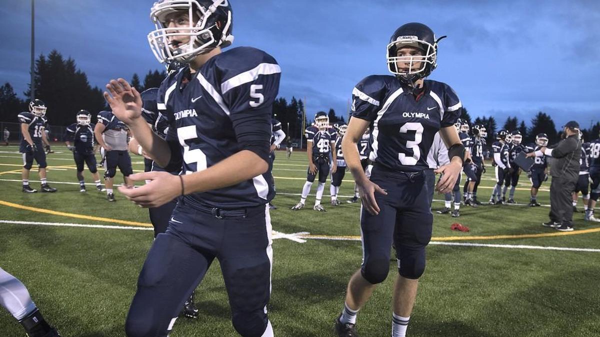 Olympia tight end Skyler Davis (5) and quarterback Jack Bell (3) warm up with the Bears before Friday night's 4A Narrows League football game against the Yelm Tornados at Ingersoll Stadium in Olympia on Oct. 30, 2015.