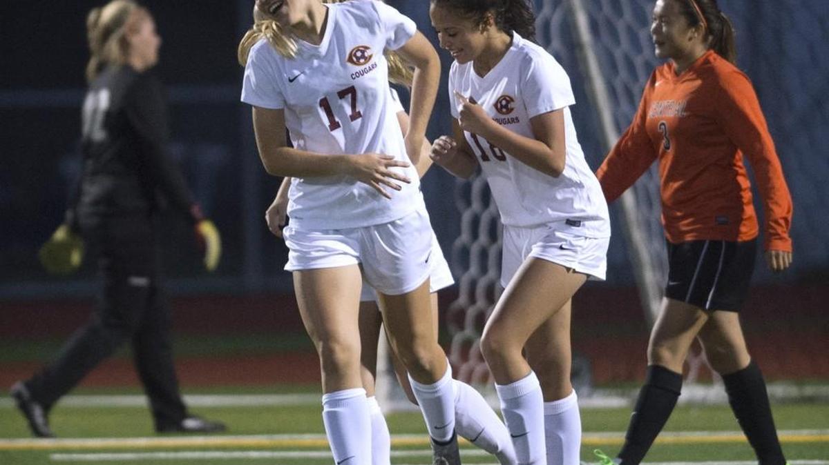 
Capital forward Madison Midstokke, left, and teammate Magnolia Winterlove celebrate Midstokke’s goal Thursday. The Cougars tied Central Kitsap, 1-1, in a showdown of unbeaten Class 3A Narrows teams.
