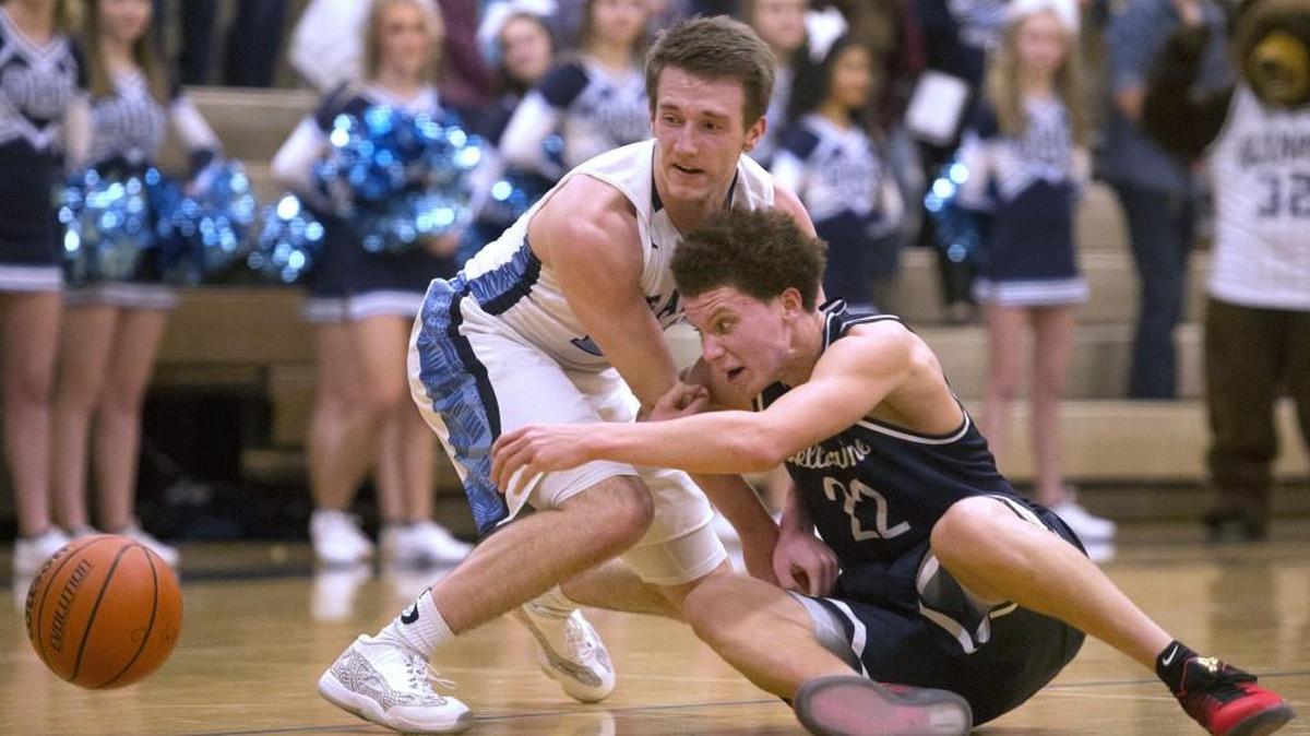 Olympia’s Liam Murphy, left, battles Bellarmine Prep’s Malachi Flynn for a loose ball during Class 4A Narrows League action last week. Both Olympia and Bellarmine Prep’s seasons have come to an end.