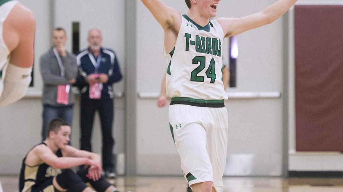 Tumwater’s Jacob Gibbon celebrates as Selah’s Elijah Pepper sits dejected on the court in the waning seconds Friday of their Class 2A state regional playoff game. Tumwater won the game, 60-54.