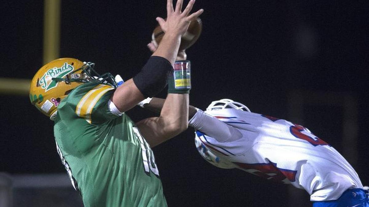 Tumwater tight end Cade Otton pulls down a pass over Washington defensive back Marquel Parks during Friday night’s opening-round of the 2A state football playoffs at Tumwater District Stadium. Tumwater won, 44-7.