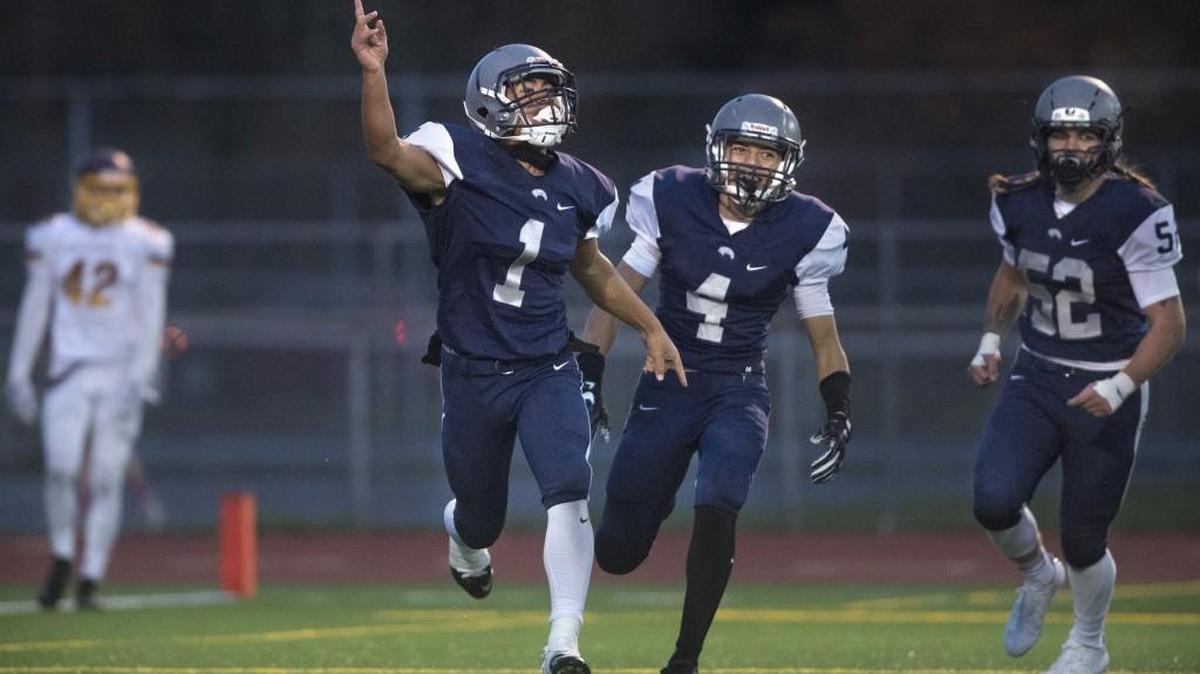 River Ridge quarterback Tomasi Manu (1), Kieran Hunkin (4) and Riley Dotson celebrate Manu’s 33-yard touchdown run, which was called back because of a penalty.