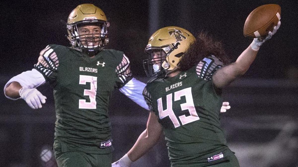Timberline's Jamin Faalogo (43) and Isaac Thompson celebrate after Faalogo recovered a Stadium Tigers fumble and carried it 33-yards for a touchdown during a district-playoff football game against Stadium at South Sound Stadium in Lacey on Nov. 3, 2017.