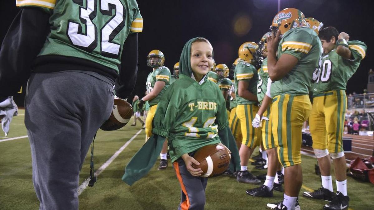 Gavin Jackson, wearing the jersey given to him by quarterback Spencer Dowers, works the sideline at a Tumwater game.