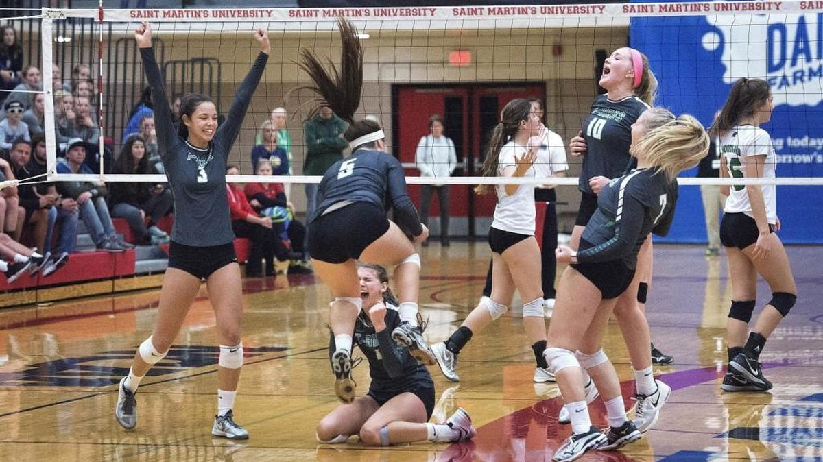 Tumwater’s Kennedy Croft, left, and her teammates start the celebration after taking the third set against Woodland to win the 2A state volleyball title in Lacey on Saturday, Nov. 12, 2016.