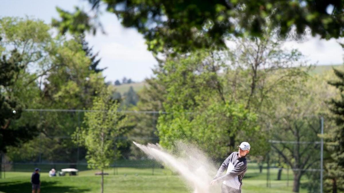 Olympia's Riley Killip hits a ball out of a sand trap during the 4a state tournament on Wednesday in Liberty Lake, Wash.