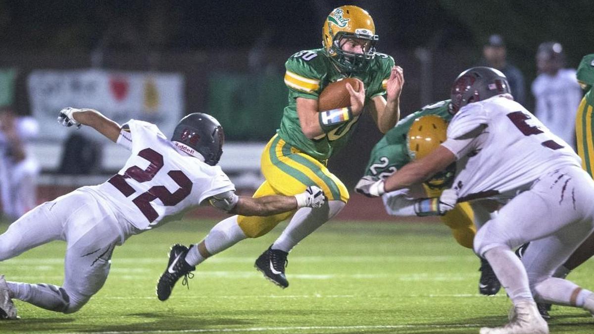Tumwater running back Dylan Paine cuts between W.F. West defenders Jett Bowers (22) and Camden Bull during a football game at Tumwater District Stadium on Oct. 27, 2017.
