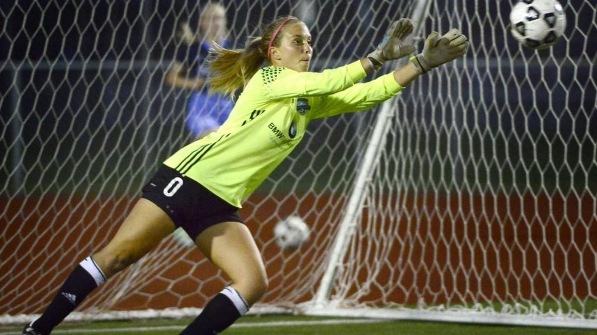Olympia High goalkeeper Carly Becker deflects the ball at Sparks Stadium in September. Becker has committed to playing soccer for the University of Portland in the fall.