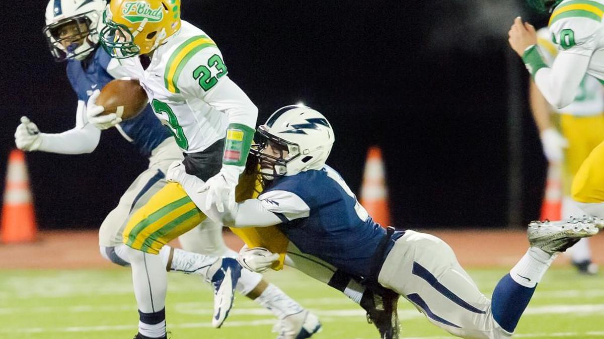 Squalicum's Ben Peterson (5) tackles Tumwater's Noah Andrews (23) preventing a touchdown during the first quarter at Civic Stadium.