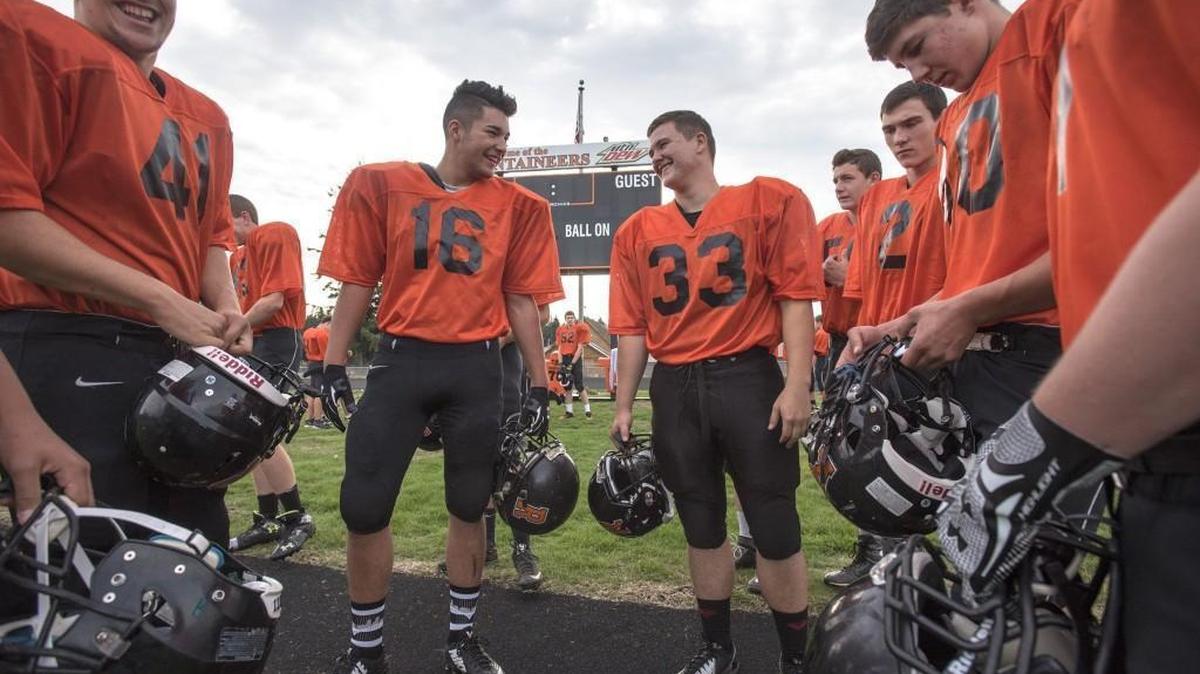 
Rainier senior linebacker Alec Miller (33) and his Mountaineer teammates gather before football practice at Rainier High School on Thursday, Oct. 8, 2015.
