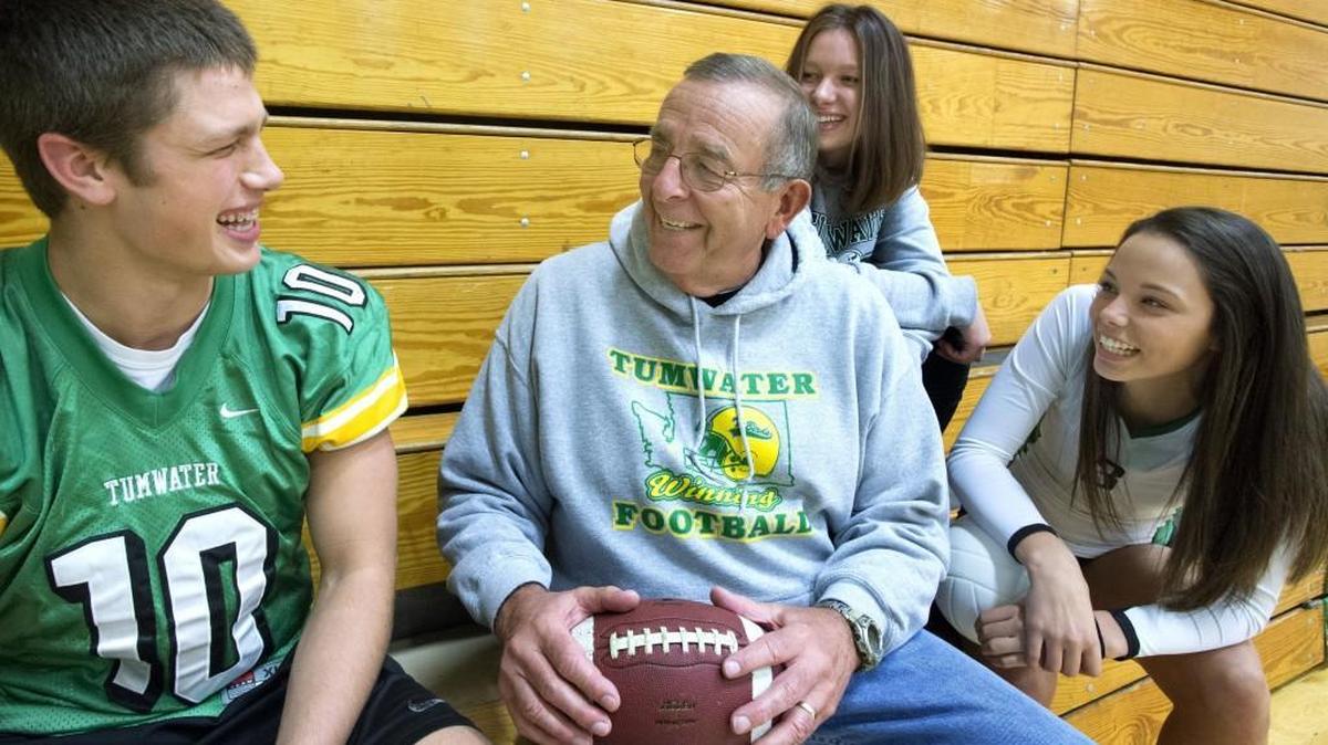 Cade Otton, left, Kylie Otton, center, and Kennedy Croft, right, listen to legendary football coach Sid Otton at Tumwater High School, are all competing in the state playoffs this weekend.