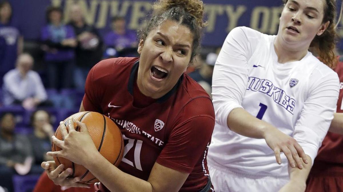 Washington State's Nike McClure (21) grabs a rebound in front of Washington's Hannah Johnson (1) in the first half of an NCAA college basketball game Sunday, Jan. 21, 2018, in Seattle.