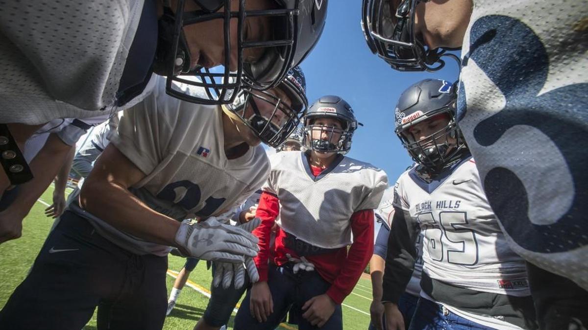 Black Hills seniors Kade Weitzel (second from left) and Wyatt Rollman (center) fire up their teammates during football practice at Black Hills High School in Tumwater.