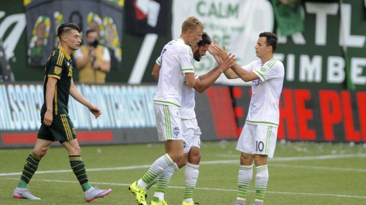 
Sounders forward Lamar Neagle, second from right, celebrates his goal against the Timbers earlier this season.
